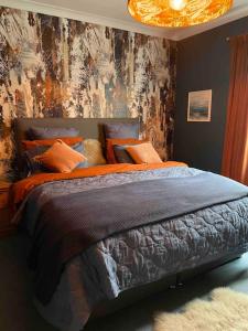 a bedroom with a large bed with a painting on the wall at Ultra Stylish furnished Home in Edinburgh in Edinburgh