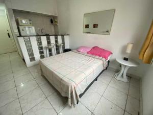 a bedroom with a bed and a table and a mirror at Residencial -Copacabana -Praia in Rio de Janeiro
