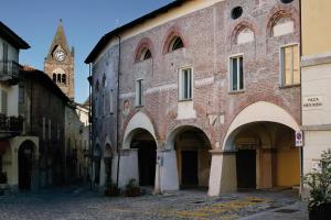 a large brick building with a clock tower in the background at Casa Conte Rosso in Avigliana +58 photos
