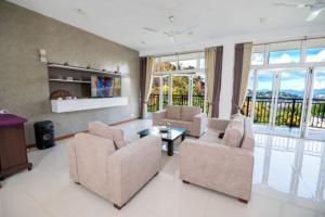 a living room with two chairs and a table at Kings Hantana in Kandy