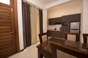 a kitchen and dining room with a table and chairs at Kings Hantana in Kandy