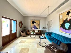 una sala de estar con un sofá azul en una habitación en Doble con desayuno incluido, Wifi gratis, estupenda piscina en Yaiza en Yaiza