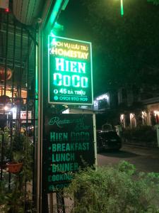 a sign for a tavern on a street at night at Hien CoCo Homestay Hoi An in Hoi An