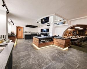a large kitchen with a island in a room at Hotel Lärchenhof in Kaunertal +101 photos