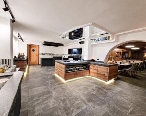 a large kitchen with a island in a room at Hotel Lärchenhof in Kaunertal