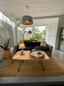 a living room with a couch and a table at La Perle de Trou d'Eau in La Saline les Bains