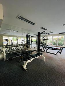 a gym with treadmills and machines in a room at Urban sathorn bangkok in Thung Maha Mek