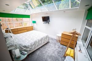 a bedroom with a bed in a room with a window at Eastfield Retreat with Hot Tub in Stannington
