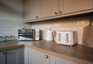 a kitchen counter with a toaster and a microwave at 22 The Old Market in Yarm