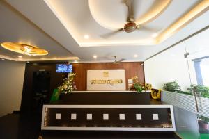 a room with a reception desk and a ceiling at Hotel Samudyatha Inn And Suites in Kundapur