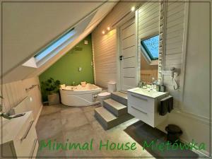 a bathroom with a toilet and a tub and a sink at Miętówka in Godziszka +21 photos