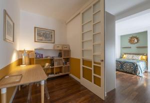 a bedroom with a bed and a desk and a table at Apartment Sun&Moon in Venice in Mestre