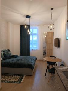 a bedroom with a bed and a table at MH Apartments in Rzeszów