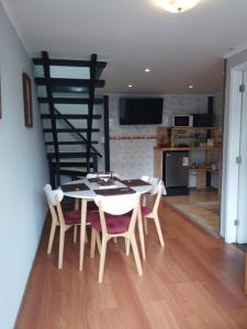 a kitchen and dining room with a table and chairs at CASA PALI 2 in Puerto Montt