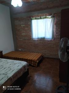 a bedroom with two beds and a window at Luna in Villa Cura Brochero