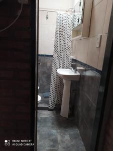 a bathroom with a sink and a shower at Luna in Villa Cura Brochero