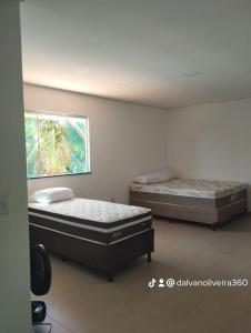 two beds sitting in a room with a wall at Casa saquaira in Praia dos Algodões +14 photos