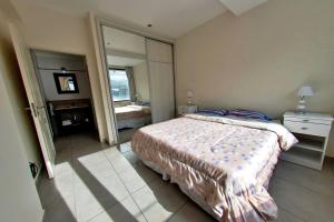 une chambre avec un lit et un grand miroir dans l'établissement Patagonia Home - New and spacious, à Ushuaia