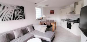 a living room with a couch and a kitchen at Ferienwohnung Eagle Nest in Winterberg in Winterberg