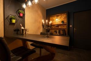 a bar with a table with candles in a room at Rien Que Nous in Moyeuvre-Grande