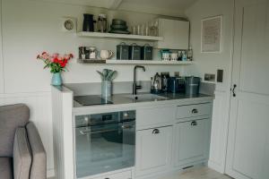 a kitchen with a sink and a counter top at Blatchford Briar - Award Winning Private Shephards Huts with their own Secluded Hot Tubs in Milton Abbot