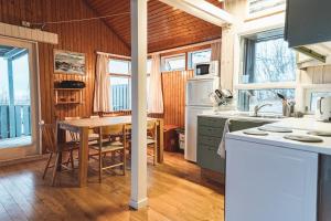 a kitchen with a table and a dining room at Old Cottages in Höfn