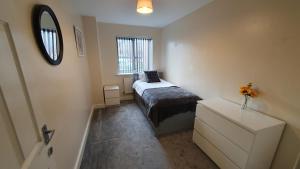 a small bedroom with a bed and a mirror at Boulevard View in Doncaster