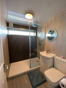 a bathroom with a shower and a toilet and a sink at Vibrant 1st Floor Apartment in Cramlington