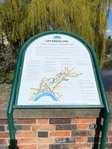 a sign on top of a brick wall at Shardlow Cottage in Derby