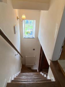 a stairway with a window in a building at Shardlow Cottage in Derby