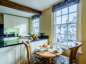 a kitchen with a table and chairs and a window at 1 Bed in Hawkshead Village LLH18 in Hawkshead