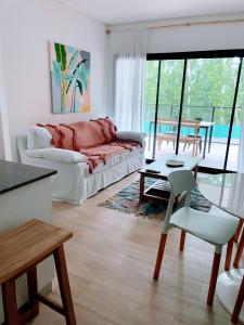 a living room with a couch and a table at Altos de la Cañada in Pilar +32 photos