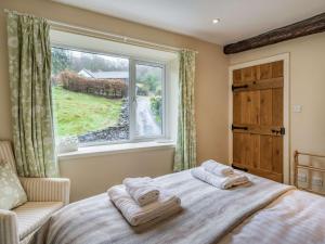 a bedroom with a bed and a window at 2 Bed in Satterthwaite and Grizedale LLH49 in Grizedale