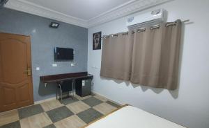 a room with a sink and curtains in it at Résidence abdou diouf in Dakar