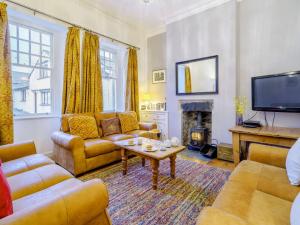 a living room with couches and a tv and a fireplace at 3 Bed in Hawkshead Village LLH21 in Hawkshead