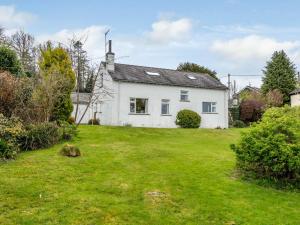 a white house with a green yard at 5 Bed in Outgate and Tarn Hows LLH55 in Hawkshead