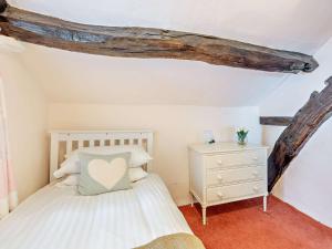 a bedroom with a white bed and a white dresser at 3 Bed in Hawkshead Village LLH39 in Hawkshead