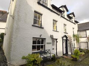 a white house with a staircase in front of it at 3 Bed in Hawkshead Village LLH39 in Hawkshead