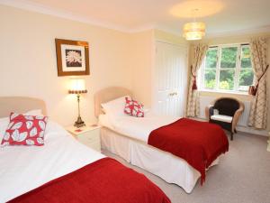 a hotel room with two beds and a window at 2 Bed in Sherborne 53673 in Chetnole
