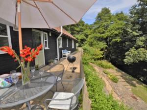 a patio with a table and chairs and an umbrella at 2 Bed in Sherborne 53673 in Chetnole