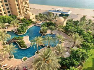 an aerial view of a resort with a swimming pool at Bespoke Holiday Homes - Palm Jumeirah- 1 Bedroom Fairmont North Residence in Dubai