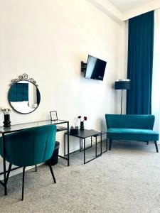 a living room with a blue couch and a mirror at Bed & Breakfast Donji Grad in Zagreb