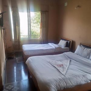 En eller flere senge i et værelse på Hotel Pacific Pokhara