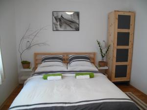 a bedroom with a large bed with two pillows at Guesthouse Bor Plitvice Lakes in Plitvička Jezera
