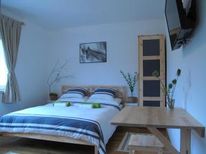 a blue bedroom with a bed and a table at Guesthouse Bor Plitvice Lakes in Plitvička Jezera