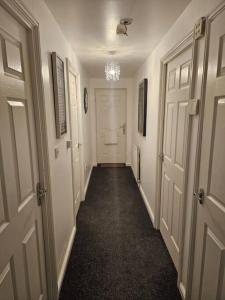 a hallway with white doors and a hallwayngth at Betjiman Retreat Relaxtion Awaits in Gateshead