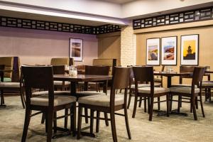 a dining room with wooden tables and chairs at Rodd Royalty in Charlottetown