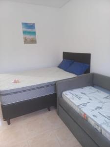 two beds sitting next to each other in a room at Pousada Lagoinha in Ubatuba