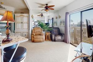 a living room with a view of a balcony at Lei Lani Village 103 in Orange Beach