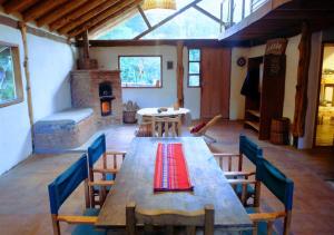a large room with a wooden table and chairs at Adobe Ecohostel in Villa Meliquina